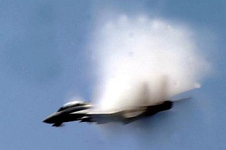 6. An F-14 Tomcat Fighter Jet From the Carrier Air Wing 8, 'Black Lions' VFA-213, United States Navy, Mediterranean Sea. Reaching the sound barrier, breaking the sound barrier: Flying at transonic speeds (flying transonically) -- speeds varying near and at the speed of sound (supersonic) -- can generate impressive condensation clouds caused by the Prandtl-Glauert Singularity. For a scientific explanation, see Professor M. S. Cramer's Gallery of Fluid Mechanics, Prandtl-Glauert Singularity at <http://www.GalleryOfFluidMechanics.com/conden/pg_sing.htm>; and Foundations of Fluid Mechanics, Navier-Stokes Equations Potential Flows: Prandtl-Glauert Similarity Laws at <http://www.Navier-Stokes.net/nspfsim.htm>. Photo Credit: Photo Credit: Photographer's Mate Airman Michael McCannCole, United States Navy; Defense Visual Information (DVI, http://www.DefenseImagery.mil, 030506-N-WX450-508) and United States Navy (USN, http://www.navy.mil), United States Department of Defense (DoD, http://www.DefenseLink.mil or http://www.dod.gov), Government of the United States of America (USA).