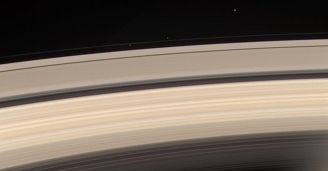 Saturn's Rings and F-Ring Shepherd Moons (Shepherding Moons) Prometheus (at left, inside the F-Ring) and Pandora (middle, outside the F-Ring), and Janus (right, top). Photo Credit: Cassini-Huygens Mission (http://saturn.jpl.nasa.gov), Cassini Orbiter, June 18, 2004; National Aeronautics and Space Administration (NASA, http://www.nasa.gov)/Jet Propulsion Laboratory (JPL, http://www.jpl.nasa.gov), Government of the United States of America (USA).