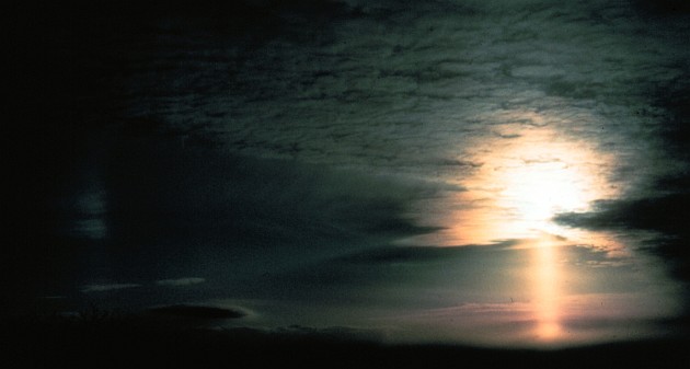 One Hour Before Sunset: Total Darkness at Left, On the Right a Sun Pillar (below the Sun) and a Sun Dog (left of the Sun). View to Southwest (SW) From Flat Top Mountain, State of North Carolina, USA. Photo Credit: Grant W. Goodge, National Oceanic and Atmospheric Administration Photo Library (http://www.photolib.noaa.gov), Historic NWS (National Weather Service) Collection, National Oceanic and Atmospheric Administration (NOAA, http://www.noaa.gov), United States Department of Commerce (http://www.commerce.gov), Government of the United States of America (USA).