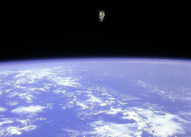 Mission Specialist Bruce McCandless II, is seen further away from the confines and safety of his ship than any previous astronaut has ever been. This space first was made possible by the Manned Manuevering Unit or MMU, a nitrogen jet propelled backpack. After a series of test maneuvers inside and above Space Shuttle Challenger's payload bay, McCandless went 'free-flying' to a distance of 320 feet away from the Orbiter. This stunning orbital panorama view shows McCandless out there amongst the black and blue of Earth and space. Photo Credit: 'EVAtion', Extravehicular Activity (EVA) Spacewalk, February 12, 1984, Space Shuttle Challenger, STS-41B, GRIN (http://grin.hq.nasa.gov) Database Number: GPN-2000-001087, National Aeronautics and Space Administration (NASA, http://www.nasa.gov), Government of the United States of America.