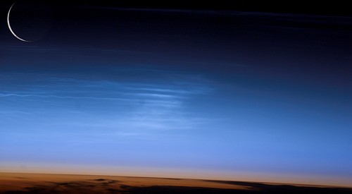 Noctilucent or Night-shining Clouds (also known as Polar Mesopheric Clouds), High Over Asia, in Earth's Mesophere. Photo Credit: Asia, Noctilucent Clouds, Moon. Sciences and Image Analysis, NASA-Johnson Space Center. 8 December 2003. 'Astronaut Photography of Earth - Quick View.' <http://eol.jsc.nasa.gov/scripts/sseop/QuickView.pl?directory=ESC&ID=ISS007-E-10973> (see also 'Strange Clouds' <http://science.nasa.gov/headlines/y2003/19feb_nlc.htm>); National Aeronautics and Space Administration (NASA, http://www.nasa.gov), Government of the United States of America (USA).