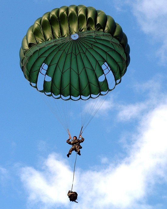 In a U.S. Military Static Line Parachute Jump, the Line Jumper is Temporarily Suspended Midair with the White Clouds in a Beautiful Blue Sky, June 24, 2002. Talofofo, Territory of Guam, USA. Photo Credit: Photographer's Mate 2nd Class Crystal Brooks, Navy NewsStand  Eye on the Fleet Photo Gallery (http://www.news.navy.mil/view_photos.asp, 020124-N-5686B-002), United States Navy (USN, http://www.navy.mil), United States Department of Defense (DoD, http://www.DefenseLink.mil or http://www.dod.gov), Government of the United States of America (USA).