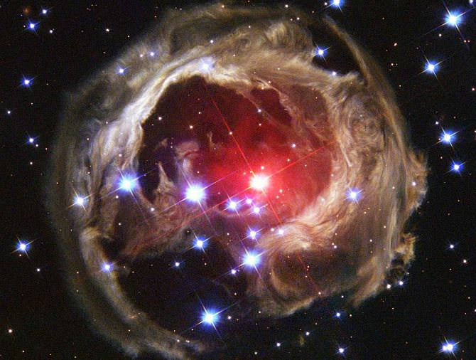 The normally faint V838 Monocerotis (center), a red supergiant star at the outer edge of our Milky Way galaxy, suddenly brightened from January 2002 to April 2002. As shown in this February 8, 2004 photo of swirls or eddies of dust swirling across trillions of miles or kilometers of interstellar space, its continuing light echo, the expanding illumination of the dusty interstellar cloud around the star, is revealing remarkable structures seen for the first time. Photo Credit: Space Phenomenon Imitates Art in Universe's Version of van Gogh Painting ('Starry Night'), February 8, 2004 (Released: March 4, 2004), STScI-2004-10, NASA's Earth-orbiting Hubble Space Telescope; The Hubble Heritage Team (AURA/STScI, http://HubbleSite.org), National Aeronautics and Space Administration (NASA, http://www.nasa.gov), Government of the United States of America (USA).