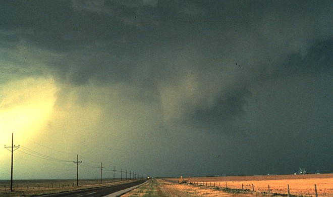 A Lonely Road, Large Dark Clouds, and the Storm Core's Thunderstorm Out Flow Showing Up as Sheets of Wind-Driven Rain Spreading From Right to Left, 1982. Photo Credit: OAR/ERL/National Severe Storms Laboratory (NSSL), National Oceanic and Atmospheric Administration Photo Library (http://www.photolib.noaa.gov, nssl0050), National Severe Storms Laboratory (NSSL) Collection, NOAA Central Library, National Oceanic and Atmospheric Administration (NOAA, http://www.noaa.gov), United States Department of Commerce (http://www.commerce.gov), Government of the United States of America (USA).