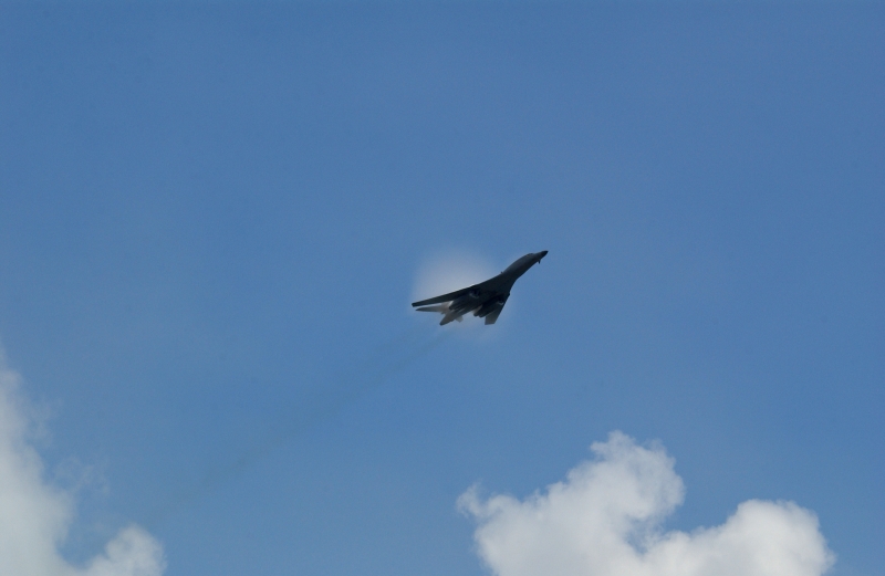 2. A B-1B Lancer Bomber Creating a Prandtl-Glauert Condensation Cloud, United States Air Force. January 16, 2004, Southwest Asia. USAF image ID number: 040116-F-0971G-142. Flying at transonic speeds -- speeds varying near and at the speed of sound (supersonic) -- can generate impressive condensation clouds caused by the Prandtl-Glauert Singularity. For a scientific explanation, see Dr. Mark. S. Cramer's Gallery of Fluid Mechanics, Prandtl-Glauert Singularity at <http://www.GalleryOfFluidMechanics.com/conden/pg_sing.htm>; the Prandtl-Glauert Condensation Clouds tutorial at <http://FluidMech.net/tutorials/sonic/prandtl-glauert-clouds.htm>; and Foundations of Fluid Mechanics, Navier-Stokes Equations Potential Flows: Prandtl-Glauert Similarity Laws at <http://www.Navier-Stokes.net/nspfsim.htm>. Photo Credit: Staff Sgt. Shelley Gill, Still Photography Journeyman, 125th Fighter Wing, Florida Air National Guard, USA; 040116-F-0971G-142, United States Air Force (USAF, http://www.af.mil), United States Department of Defense (DoD, http://www.DefenseLink.mil or http://www.dod.gov), Government of the United States of America (USA).