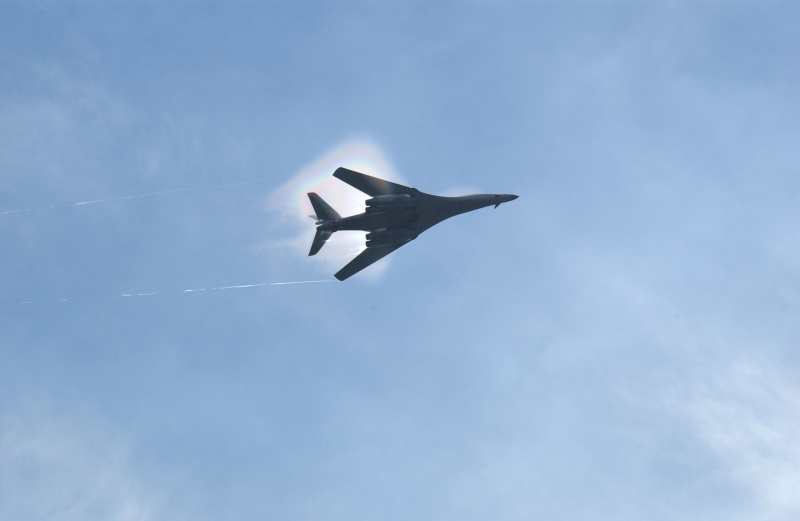 8. A B-1B Lancer Bomber Creating a Prandtl-Glauert Condensation Cloud, United States Air Force. January 16, 2004, Southwest Asia. USAF image ID number: 040116-F-0971G-151. Flying at transonic speeds -- speeds varying near and at the speed of sound (supersonic) -- can generate impressive condensation clouds caused by the Prandtl-Glauert Singularity. For a scientific explanation, see Dr. Mark. S. Cramer's Gallery of Fluid Mechanics, Prandtl-Glauert Singularity at <http://www.GalleryOfFluidMechanics.com/conden/pg_sing.htm>; the Prandtl-Glauert Condensation Clouds tutorial at <http://FluidMech.net/tutorials/sonic/prandtl-glauert-clouds.htm>; and Foundations of Fluid Mechanics, Navier-Stokes Equations Potential Flows: Prandtl-Glauert Similarity Laws at <http://www.Navier-Stokes.net/nspfsim.htm>. Photo Credit: Staff Sgt. Shelley Gill, Still Photography Journeyman, 125th Fighter Wing, Florida Air National Guard, USA; 040116-F-0971G-151, United States Air Force (USAF, http://www.af.mil), United States Department of Defense (DoD, http://www.DefenseLink.mil or http://www.dod.gov), Government of the United States of America (USA).