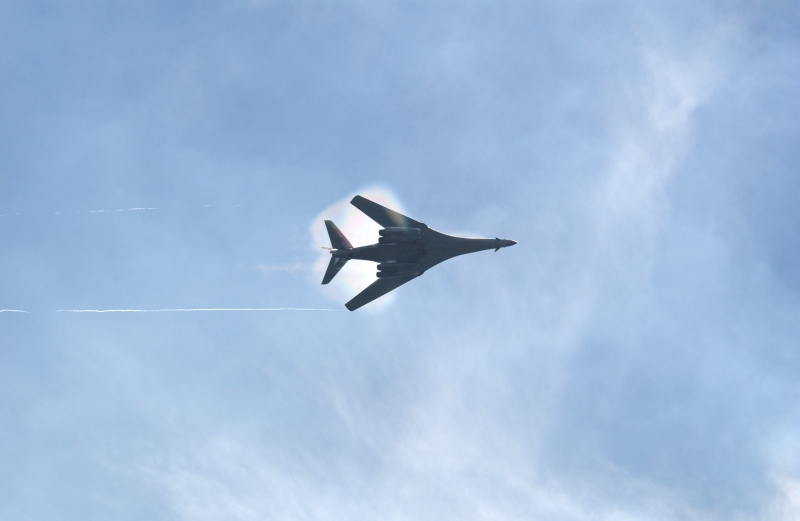 9. A B-1B Lancer Bomber Creating a Prandtl-Glauert Condensation Cloud, United States Air Force. January 16, 2004, Southwest Asia. USAF image ID number: 040116-F-0971G-152. Flying at transonic speeds -- speeds varying near and at the speed of sound (supersonic) -- can generate impressive condensation clouds caused by the Prandtl-Glauert Singularity. For a scientific explanation, see Dr. Mark. S. Cramer's Gallery of Fluid Mechanics, Prandtl-Glauert Singularity at <http://www.GalleryOfFluidMechanics.com/conden/pg_sing.htm>; the Prandtl-Glauert Condensation Clouds tutorial at <http://FluidMech.net/tutorials/sonic/prandtl-glauert-clouds.htm>; and Foundations of Fluid Mechanics, Navier-Stokes Equations Potential Flows: Prandtl-Glauert Similarity Laws at <http://www.Navier-Stokes.net/nspfsim.htm>. Photo Credit: Staff Sgt. Shelley Gill, Still Photography Journeyman, 125th Fighter Wing, Florida Air National Guard, USA; 040116-F-0971G-152, United States Air Force (USAF, http://www.af.mil), United States Department of Defense (DoD, http://www.DefenseLink.mil or http://www.dod.gov), Government of the United States of America (USA).