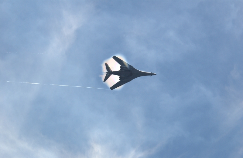 10. A B-1B Lancer Bomber Creating a Prandtl-Glauert Condensation Cloud, United States Air Force. January 16, 2004, Southwest Asia. USAF image ID number: 040116-F-0971G-153. Flying at transonic speeds -- speeds varying near and at the speed of sound (supersonic) -- can generate impressive condensation clouds caused by the Prandtl-Glauert Singularity. For a scientific explanation, see Dr. Mark. S. Cramer's Gallery of Fluid Mechanics, Prandtl-Glauert Singularity at <http://www.GalleryOfFluidMechanics.com/conden/pg_sing.htm>; the Prandtl-Glauert Condensation Clouds tutorial at <http://FluidMech.net/tutorials/sonic/prandtl-glauert-clouds.htm>; and Foundations of Fluid Mechanics, Navier-Stokes Equations Potential Flows: Prandtl-Glauert Similarity Laws at <http://www.Navier-Stokes.net/nspfsim.htm>. Photo Credit: Staff Sgt. Shelley Gill, Still Photography Journeyman, 125th Fighter Wing, Florida Air National Guard, USA; 040116-F-0971G-153, United States Air Force (USAF, http://www.af.mil), United States Department of Defense (DoD, http://www.DefenseLink.mil or http://www.dod.gov), Government of the United States of America (USA).