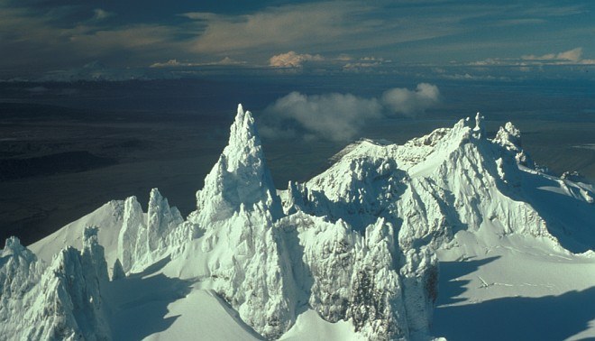 The Lofty Aghileen Pinnacles (foreground), in the Background, Frosty, Roundtop, Isanotski and Shishaldin. Izembek National Wildlife Refuge, State of Alaska, USAPhoto Credit: John Sarvis, Alaska Historical Image Library, United States Fish and Wildlife Service Digital Library System (http://images.fws.gov, AK/RO/03146), United States Fish and Wildlife Service (FWS, http://www.fws.gov), United States Department of the Interior (http://www.doi.gov), Government of the United States of America (USA).