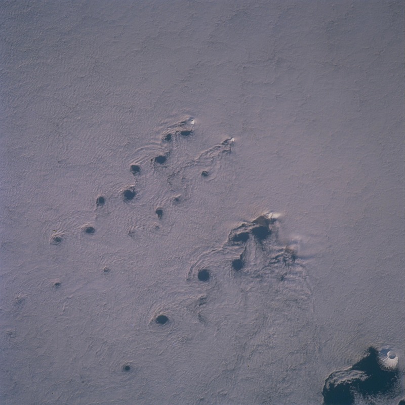 11. Total Cloud Cover Over the Islands, von Karman Vortices, and the von Karman Vortex Street, State of Alaska in 2001, As Seen From the International Space Station (Expedition 2). Photo Credit: NASA; ISS002-712-94, 100% cloud cover, von Karman vortices, von Karman vortex street, Snow-capped volcano peak, International Space Station (Expedition Two); Image Science and Analysis Laboratory, NASA-Johnson Space Center. 'Astronaut Photography of Earth - Display Record.' <http://eol.jsc.nasa.gov/scripts/sseop/photo.pl?mission=ISS002&roll=712&frame=94>; National Aeronautics and Space Administration (NASA, http://www.nasa.gov), Government of the United States of America (USA).