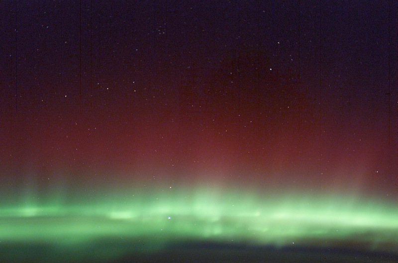 4. Shimmering Red Aurora Borealis and Green Aurora Borealis (Northern Lights), March 30, 2003 As Seen From the International Space Station (Expedition 6). Photo Credit: NASA; ISS006-E-41616, Red and Green Aurora Borealis, Stars, International Space Station (Expedition Six); Image Science and Analysis Laboratory, NASA-Johnson Space Center. 'Astronaut Photography of Earth - Display Record.' <http://eol.jsc.nasa.gov/scripts/sseop/photo.pl?mission=ISS006&roll=E&frame=41616>; National Aeronautics and Space Administration (NASA, http://www.nasa.gov), Government of the United States of America (USA).