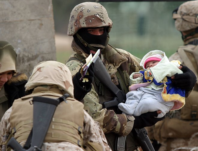 This Bundled-Up Colorfully-Dressed Baby, Nestled in a Soldier's Protective Arms and Surrounded by Soldiers, Rests Without Worry, January 30, 2005. Nasarwasalam, Al Jumhuriyah al Iraqiyah - Republic of Iraq. Photo Credit: Cpl. Trevor Gift of the United States Marine Corps (USMC, http://www.usmc.mil), Navy NewsStand - Eye on the Fleet Photo Gallery (http://www.news.navy.mil/view_photos.asp, 050130-M-7981G-034), United States Navy (USN, http://www.navy.mil); United States Department of Defense (DoD, http://www.DefenseLink.mil or http://www.dod.gov), Government of the United States of America (USA).