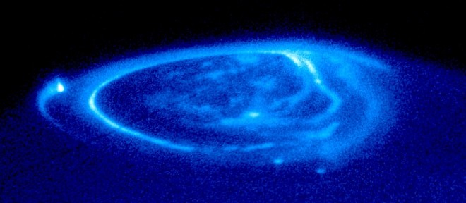 Electric Currents From Three Jupiter Moons - Io, Ganymede, and Europa - Contribute to This Spectacular Blue Aurora Located at Jupiter's Magnetic North Pole. Photo Credit: Satellite Footprints Seen in Jupiter Aurora, November 26, 1998 (Release date: December 14, 2000), STScI-2000-38, NASA's Earth-orbiting Hubble Space Telescope (http://HubbleSite.org); European Space Agency (ESA, http://SpaceTelescope.org), John Clarke (University of Michigan), National Aeronautics and Space Administration (NASA, http://www.nasa.gov), Government of the United States of America (USA). Acknowledgment: Ray A. Lucas (STScI/AURA).