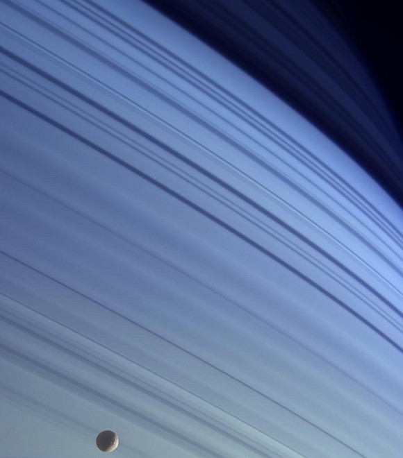 Beautiful True Color View of Saturn's Blue Skies in the Northern Hemisphere, Saturn's Moon Mimas (foreground), and Shadows of the Planet's Majestic Rings Visible As Long, Dark Lines On the Atmosphere. Photo Credit: Cassini-Huygens Mission (http://saturn.jpl.nasa.gov), Cassini Orbiter, January 18, 2005; Planetary Photojournal (http://photojournal.jpl.nasa.gov, PIA06176), National Aeronautics and Space Administration (NASA, http://www.nasa.gov)/Jet Propulsion Laboratory (JPL, http://www.jpl.nasa.gov)/Space Science Institute (http://ciclops.org), Government of the United States of America. See also Science@NASA: Blue Skies on Saturn <http://science.nasa.gov/headlines/y2005/17feb_bluesaturn.htm> by Dr. Tony Phillips, February 17, 2005.