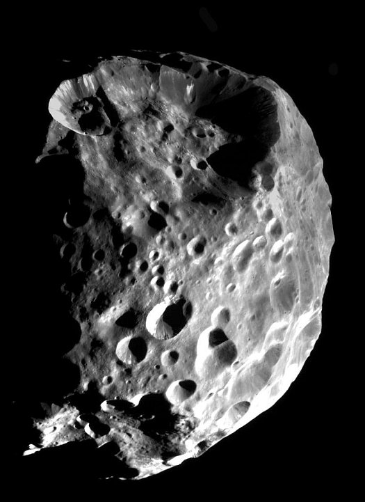 A Spectacular View of Phoebe, a Moon of the Planet Saturn, Approximately 32,500 Kilometers (20,200 Miles) From the Cameras Aboard the Cassini Orbiter, June 11, 2004. Photo Credit: Cassini-Huygens Mission (http://saturn.jpl.nasa.gov), Cassini Orbiter, June 11, 2004; Planetary Photojournal (http://photojournal.jpl.nasa.gov, PIA06064), National Aeronautics and Space Administration (NASA, http://www.nasa.gov)/Jet Propulsion Laboratory (JPL, http://www.jpl.nasa.gov)/Space Science Institute (http://ciclops.org), Government of the United States of America.