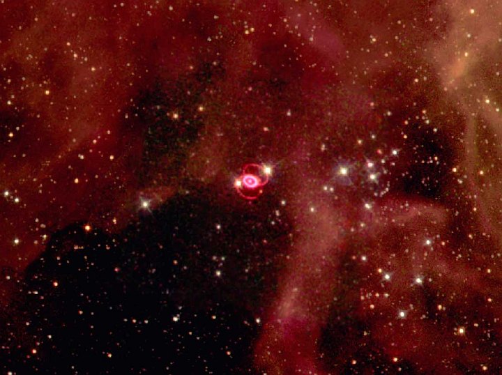 In a Spectacular Settting of Clouds of Gas and Many Very Massive Stars in the Large Magellanic Cloud, a Galaxy Near Our Own Milky Way Galaxy, are the Beautiful Inner and Outer Rings Surrounding the Glowing Debris of Supernova 1987A or SN 1987A -- a Lightshow in the Heavens. Photo Credit: SN1987a in the Large Magellanic Cloud, September 1994, February 1996 and July 1997 (Release date: February 4, 1999), STScI-1999-04, NASA's Earth-orbiting Hubble Space Telescope (http://HubbleSite.org); The Hubble Heritage Team (STScI/AURA), National Aeronautics and Space Administration (NASA, http://www.nasa.gov), Government of the United States of America (USA).