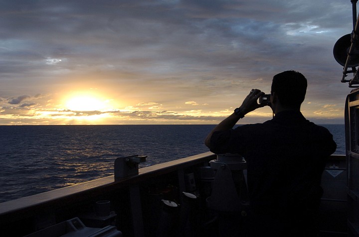 Photographing a Sunset -- the Start of a New Day -- in the Coral Sea. Photo Credit: Photographer's Mate 3rd Class Bo Flannigan, Navy NewsStand - Eye on the Fleet Photo Gallery (http://www.news.navy.mil/view_photos.asp, 050621-N-5781F-175), United States Navy (USN, http://www.navy.mil); United States Department of Defense (DoD, http://www.DefenseLink.mil or http://www.dod.gov), Government of the United States of America (USA).