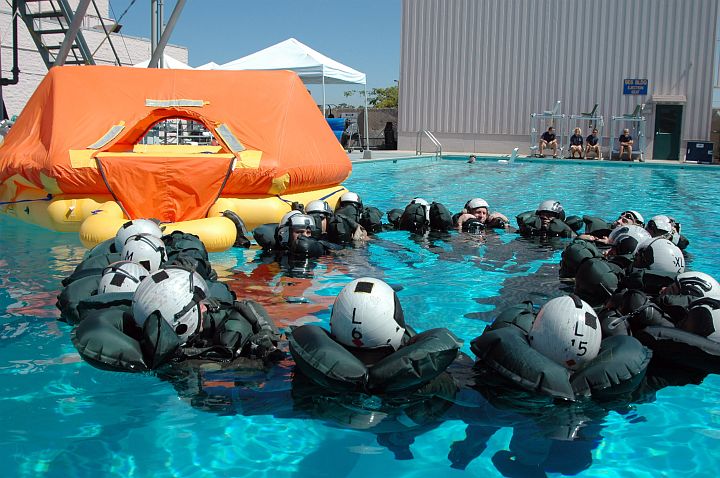 We Will -- We Must -- Stay Together: Seventeen (17) U.S. Navy Air Crewman Form a Circle in the Swimming Pool as They Simulate Open Ocean Survival Procedures to Prevent Anyone From Drifting Off Alone. Aviation Survival Training Center Miramar, Miramar, State of California, USA. Photo Credit: Photographer's Mate 2nd Class Daniel R. Mennuto, Navy NewsStand - Eye on the Fleet Photo Gallery (http://www.news.navy.mil/view_photos.asp, 050927-N-7286M-015), United States Navy (USN, http://www.navy.mil), United States Department of Defense (DoD, http://www.DefenseLink.mil or http://www.dod.gov), Government of the United States of America (USA).