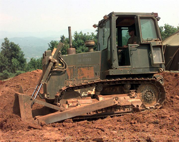 United States Navy Seebee's Use Heavy Equipment, a Bulldozer, to Flatten Out the Ground at Camp Wedge, Naval Mobile Construction Battalion FOUR (NMCB FOUR) on June 16, 1999 in Tirana, Republika e Shqiperise (Shqiperia) - Republic of Albania. Photo Credit: Photographer's Mate 2nd Class Brian McFadden, Navy NewsStand - Eye on the Fleet Photo Gallery (http://www.news.navy.mil/view_photos.asp, 990616-N-6019M-509), United States Navy (USN, http://www.navy.mil); United States Department of Defense (DoD, http://www.DefenseLink.mil or http://www.dod.gov), Government of the United States of America (USA).