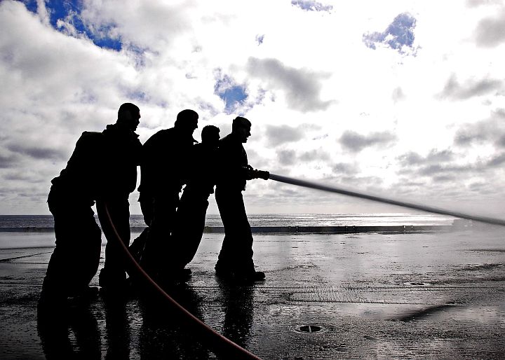 These Five (5) Sailors are Working Together as a Single Unit to Wash Down the Flight Deck of the Aircraft Carrier USS Abraham Lincoln (CVN 72), United States Navy in the Pacific Ocean. Photo Credit: Photographer's Mate Airman Jordon R. Beesley, Navy NewsStand - Eye on the Fleet Photo Gallery (http://www.news.navy.mil/view_photos.asp, 050622-N-4166B-010), United States Navy (USN, http://www.navy.mil); United States Department of Defense (DoD, http://www.DefenseLink.mil or http://www.dod.gov), Government of the United States of America (USA).