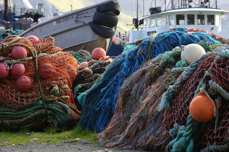 Docked Ships and a Very Colorful Pile of Fishing Nets at Dutch Harbor, Alaska Maritime National Wildlife Refuge, Unalaska, Aleutian Islands, State of Alaska, USA. Photo Credit: Carla Stanley, Alaska Image Library, United States Fish and Wildlife Service Digital Library System (http://images.fws.gov), United States Fish and Wildlife Service (FWS, http://www.fws.gov), United States Department of the Interior (http://www.doi.gov), Government of the United States of America (USA).