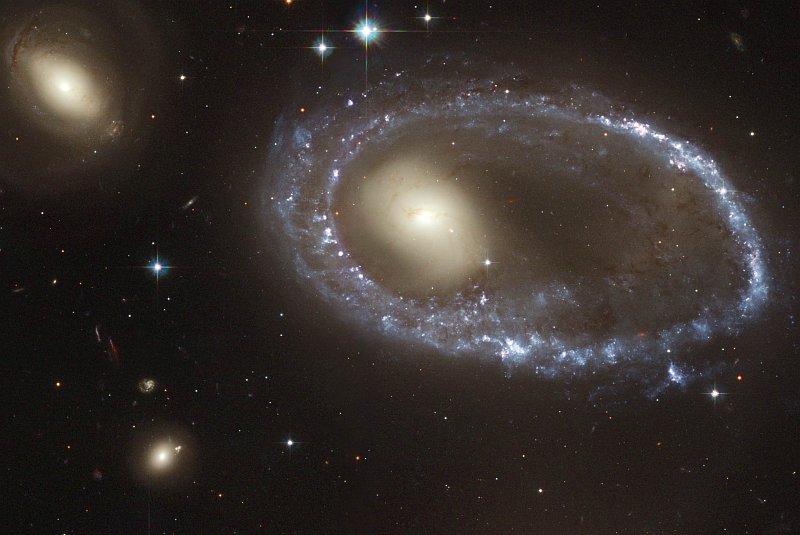 A Lovely and Spectacular View of Ring Galaxy AM 0644-741 (Lindsay-Shapley Ring Galaxy), Completely Surrounded By a Beautiful, Sparkling Ring of Blue Stars Located in the Constellation Volans. Photo Credit: Blue Stars Ring Nucleus of Galaxy AM 0644-741, January 16, 2004 and January 17, 2004 (Release date: April 22, 2004), STScI-2004-15, NASA's Earth-orbiting Hubble Space Telescope (http://HubbleSite.org); The Hubble Heritage Team (STScI/AURA), European Space Agency (ESA, http://SpaceTelescope.org), National Aeronautics and Space Administration (NASA, http://www.nasa.gov), Government of the United States of America (USA). Acknowledgment: J. Higdon (Cornell University) and I. Jordan (STScI).