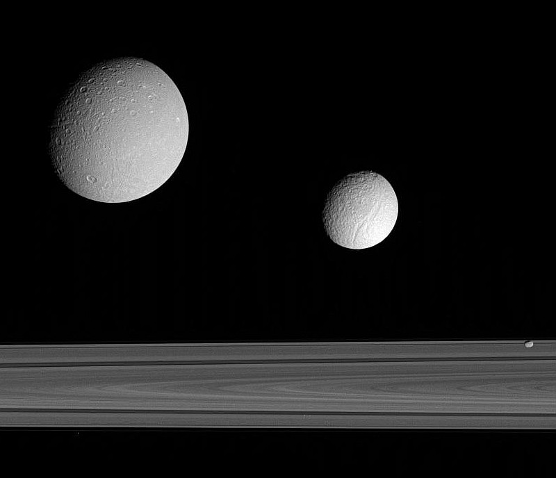 Splendid View of Three Saturnian Moons Near Planet Saturn's Broad and Majestic Rings: Dione (Top Left), Tethys (Center), and F-Ring Shepherd Moon Pandora (Lower Right). Photo Credit: Satellite Trio, Cassini-Huygens Mission (http://saturn.jpl.nasa.gov), Cassini Orbiter, September 2005; Planetary Photojournal (http://photojournal.jpl.nasa.gov, PIA07628), National Aeronautics and Space Administration (NASA, http://www.nasa.gov)/Jet Propulsion Laboratory (JPL, http://www.jpl.nasa.gov), Government of the United States of America.