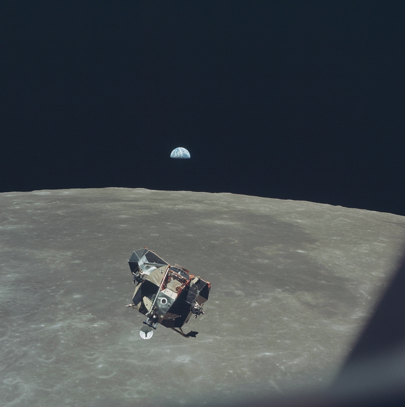 26. Beautiful, Half-Illuminated, White-and-Blue Earth Backdrops the Liftoff of the NASA Apollo 11 Lunar Module ('Eagle') From the Moon's Surface, July 21, 1969 (19690721), As Seen From the Orbiting NASA Apollo 11 Command and Service Modules ('Columbia'). Photo Credit: NASA Astronaut Michael Collins; AS11-44-6642, Earth, Moon surface, Apollo 11 Lunar Module 'Eagle' ascent stage, Orbiting Apollo 11 Command and Service Modules (CSM) 'Columbia', Apollo XI Mission; Image Science and Analysis Laboratory, NASA-Johnson Space Center. 'Astronaut Photography of Earth - Display Record.' <http://eol.jsc.nasa.gov/scripts/sseop/photo.pl?mission=AS11&roll=44&frame=6642>; National Aeronautics and Space Administration (NASA, http://www.nasa.gov), Government of the United States of America (USA).