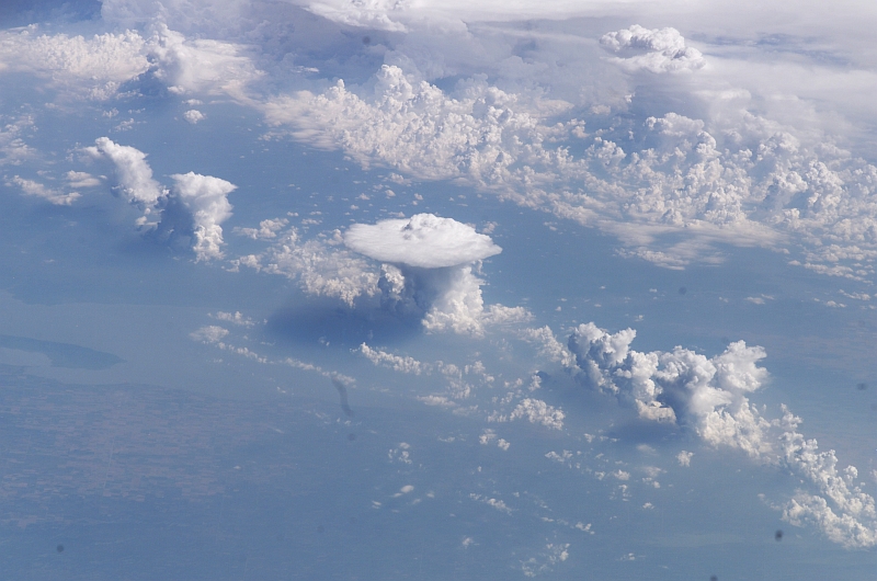 31. Cumulonimbus Clouds and Anvils Over Canada, North America, August 19, 2003 at 18:13:39.563 GMT As Seen From the International Space Station (Expedition 7), Latitude (LAT): 49.6, Longitude (LON): -113.1, Altitude (ALT): 202 Nautical Miles, Sun Azimuth (AZI): 148 degrees, Sun Elevation Angle (ELEV): 50 degrees. Photo Credit: NASA; ISS007-E-13020, Cumulonimbus Clouds and Anvils, Canada, United States of America, North America, International Space Station (Expedition Seven); Image Science and Analysis Laboratory, NASA-Johnson Space Center. 'Astronaut Photography of Earth - Display Record.' <http://eol.jsc.nasa.gov/scripts/sseop/photo.pl?mission=ISS007&roll=E&frame=13020>; National Aeronautics and Space Administration (NASA, http://www.nasa.gov), Government of the United States of America (USA).