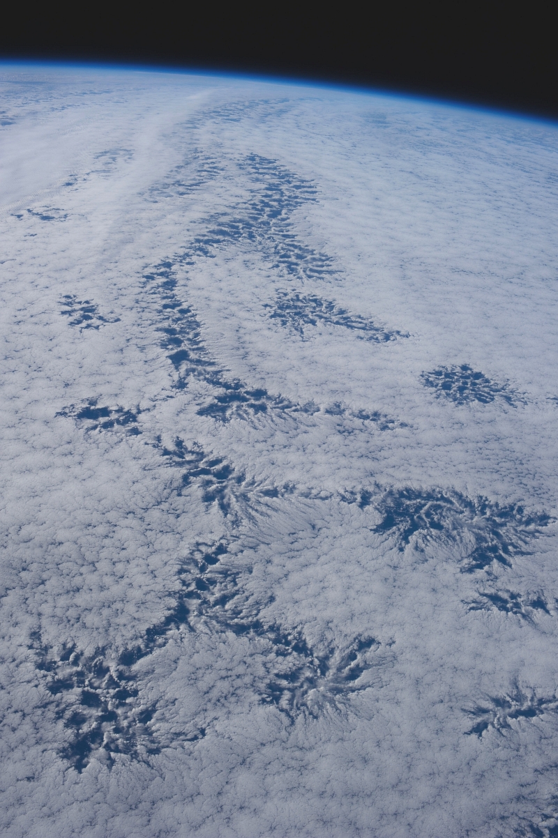 48. Cloud Patterns, July 26, 2013 at 20:40:51 GMT, As Seen From the International Space Station (Expedition 36) While Orbiting Over the South Pacific Ocean, Latitude (LAT): -44.3, Longitude (LON): -113.1, Altitude (ALT): 226 Nautical Miles, Sun Azimuth (AZI): 344 degrees, Sun Elevation Angle (ELEV): 25 degrees. Photo Credit: NASA; ISS036-E-25843, International Space Station (Expedition 36); Image Science and Analysis Laboratory, NASA-Johnson Space Center. 'The Gateway to Astronaut Photography of Earth.' <http://eol.jsc.nasa.gov/scripts/sseop/photo.pl?mission=ISS036&roll=E&frame=25843>; National Aeronautics and Space Administration (NASA, http://www.nasa.gov), Government of the United States of America (USA).