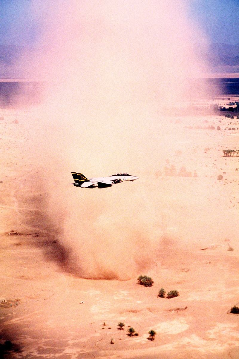5. A United States Navy F-14A Tomcat Assigned to the 'Swordsmen' of Fighter Squadron Three Two (VF-32) Flies By a Very Big, Very Tall, Column-Shaped Desert Sandstorm, September 1, 1990, In the Vicinity of the Red Sea. Photo Credit: Lt. Cmdr. Dave Parsons, United States Navy (USN, http://www.navy.mil); Defense Visual Information Center (DVIC, http://www.DoDMedia.osd.mil, DNST9102741) and United States Navy (USN, http://www.navy.mil), United States Department of Defense (DoD, http://www.DefenseLink.mil or http://www.dod.gov), Government of the United States of America (USA).