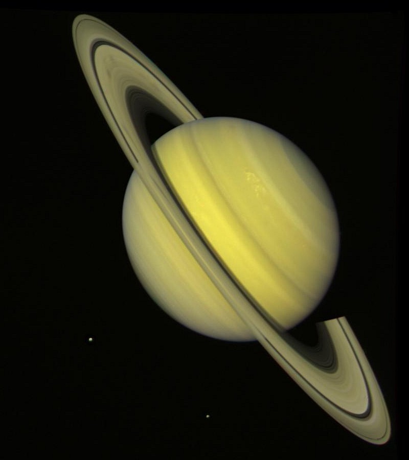 Beautiful and Majestic Saturn, a Planet In Our Solar System, With Rhea and Dione, Two of Its Many Satellites (Moons). Photo Credit: Voyager Mission (http://voyager.jpl.nasa.gov), Voyager 2, July 21, 1981; Planetary Photojournal (http://photojournal.jpl.nasa.gov, PIA00030), National Aeronautics and Space Administration (NASA, http://www.nasa.gov)/Jet Propulsion Laboratory (JPL, http://www.jpl.nasa.gov), Government of the United States of America.