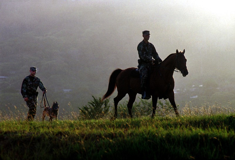 Guarding and Patrolling the Perimeter on Foot and Horseback, November 1999, Howard Air Force Base, Republica de Panama - Republic of Panama. Photo Credit: SSgt. Gary Coppage, United States Air Force; Defense Visual Information Center (DVIC, http://www.DoDMedia.osd.mil, DFSD0108694 and 991101F3500C007) and United States Air Force (USAF, http://www.af.mil), United States Department of Defense (DoD, http://www.DefenseLink.mil or http://www.dod.gov), Government of the United States of America (USA).