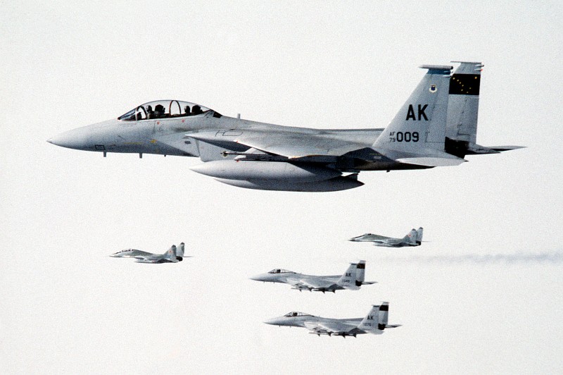 2. Three (3) Visible United States Air Force F-15 Eagle Fighter Jets, Assigned to 21st Tactical Fighter Wing, Escort Two (2) Soviet MiG-29 Fighter Aircraft to Elmendorf Air Force Base For Refueling, August 1989, State of Alaska, USA. Photo Credit: Sgt. Gregory A. Suhay, United States Air Force (USAF, http://www.af.mil); Defense Visual Information Center (DVIC, http://www.DoDMedia.osd.mil, DFST9005774) and United States Air Force (USAF, http://www.af.mil), United States Department of Defense (DoD, http://www.DefenseLink.mil or http://www.dod.gov), Government of the United States of America (USA).