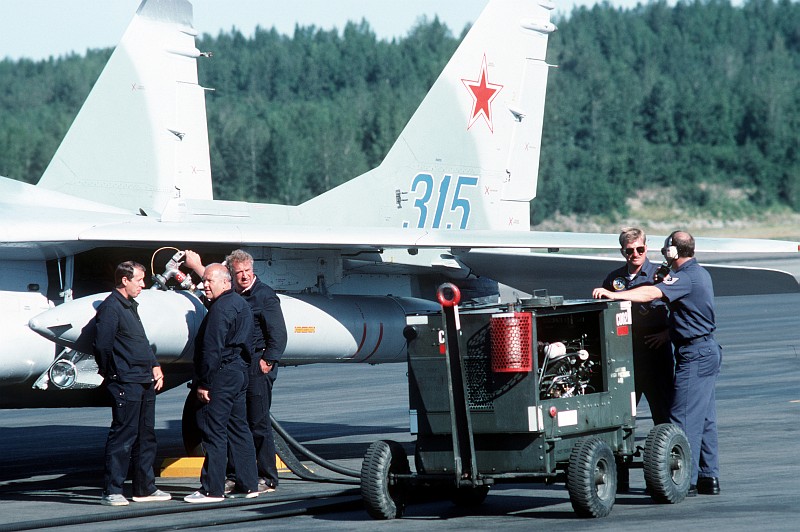 4. USSR and USA Maintenance Personnel Refuel a Soviet MiG-29 Fighter Jet (Tail Number 315), August 1989, Elmendorf Air Force Base, State of Alaska, USA. Photo Credit: Sgt. Gregory A. Suhay, United States Air Force (USAF, http://www.af.mil); Defense Visual Information Center (DVIC, http://www.DoDMedia.osd.mil, DFST9005770) and United States Air Force (USAF, http://www.af.mil), United States Department of Defense (DoD, http://www.DefenseLink.mil or http://www.dod.gov), Government of the United States of America (USA).