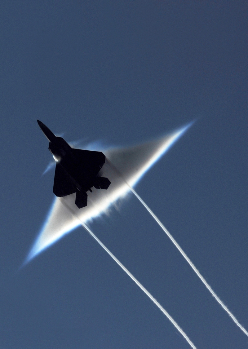 3. Condensation Cloud and Wingtip Vortices: A United States Air Force F-22A Raptor Stealth Fighter Jet, June 22, 2009, High-Speed Flyby Above the United States Navy's Nimitz-Class Aircraft Carrier USS John C. Stennis (CVN 74) During Northern Edge 2009 in the Gulf of Alaska, State of Alaska, USA. Photo Credit: Mass Communication Specialist 2nd Class Kyle Steckler, United States Navy; Defense Visual Information (DVI, http://www.DefenseImagery.mil, 090622-N-7780S-014) and United States Navy (USN, http://www.navy.mil), United States Department of Defense (DoD, http://www.DefenseLink.mil or http://www.dod.gov), Government of the United States of America (USA).