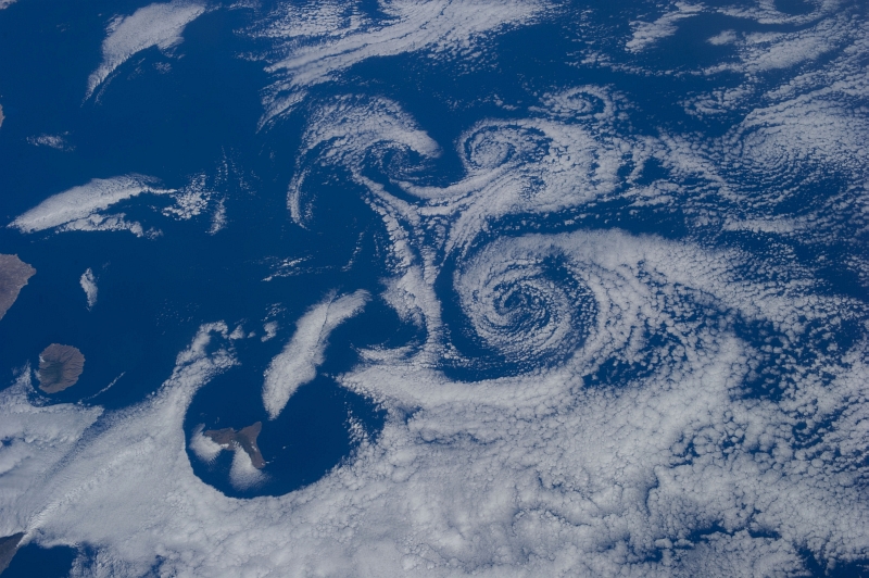 3. Clouds and Vortices Over the Atlantic Ocean As Seen From the International Space Station (Expedition 36) on July 6, 2013 at 17:29:16 GMT, Latitude (LAT): 27.3, Longitude (LON): -19.7, Altitude (ALT): 219 Nautical Miles, Sun Azimuth (AZI): 280 degrees, Sun Elevation Angle (ELEV): 35 degrees. Photo Credit: NASA; ISS036-E-16261, International Space Station (Expedition 36); Image Science and Analysis Laboratory, NASA-Johnson Space Center. 'The Gateway to Astronaut Photography of Earth.' <http://eol.jsc.nasa.gov/scripts/sseop/photo.pl?mission=ISS036&roll=E&frame=16261>; National Aeronautics and Space Administration (NASA, http://www.nasa.gov), Government of the United States of America (USA).