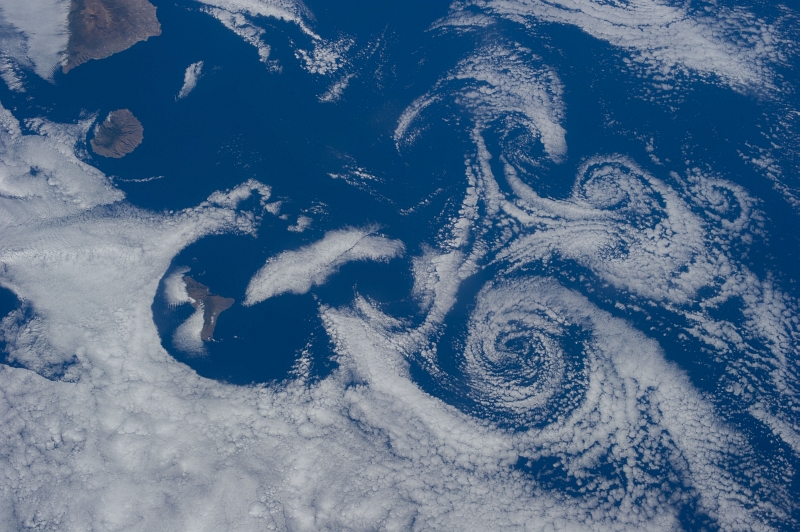 4. Clouds and Vortices Over the Atlantic Ocean As Seen From the International Space Station (Expedition 36) on July 6, 2013 at 17:29:31 GMT, Latitude (LAT): 26.6, Longitude (LON): -19.0, Altitude (ALT): 219 Nautical Miles, Sun Azimuth (AZI): 281 degrees, Sun Elevation Angle (ELEV): 34 degrees. Photo Credit: NASA; ISS036-E-16264, International Space Station (Expedition 36); Image Science and Analysis Laboratory, NASA-Johnson Space Center. 'The Gateway to Astronaut Photography of Earth.' <http://eol.jsc.nasa.gov/scripts/sseop/photo.pl?mission=ISS036&roll=E&frame=16264>; National Aeronautics and Space Administration (NASA, http://www.nasa.gov), Government of the United States of America (USA).