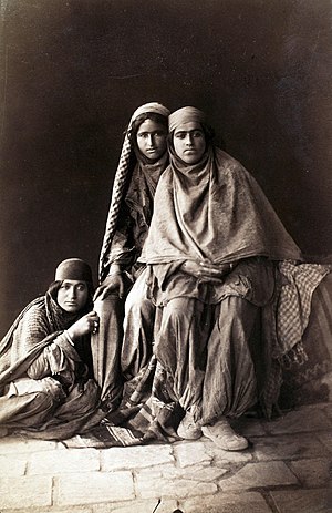 Three women tiredly look at Antoin Sevruguin as he photographs them in the late 19th century