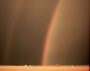 Mananaf (Jnio) 2, 2004, Salmo 145:8-9. Rainbow with reflection over an Oklahoma wheatfield.