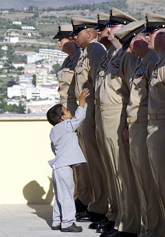 2. An eager little boy breaks from the gathered crowd to congratulate his father, a newly frocked chief petty officer, September 16, 2003. Naval Support Activity Gaeta, Repubblica Italiana - Italian Republic (Italy). Photo Credit: Photographer's Mate 1st Class Paul J. Phelps, Navy NewsStand - Eye on the Fleet Photo Gallery (http://www.news.navy.mil/view_photos.asp, 030916-N-2716P-120), United States Navy (USN, http://www.navy.mil), United States Department of Defense (DoD, http://www.DefenseLink.mil or http://www.dod.gov), Government of the United States of America (USA).