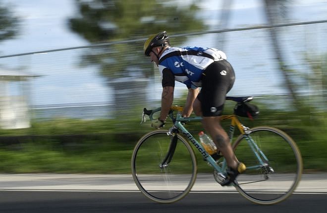 A Cyclist Pedals Hard on His Bicycle in the Guam Triathlon Federation's October 2003 Triathlon, October 12, 2003. Piti, Territory of Guam, USA. Photo Credit: Photographer's Mate 2nd Class Nathanael T. Miller, Navy NewsStand - Eye on the Fleet Photo Gallery (http://www.news.navy.mil/view_photos.asp, 031012-N-7293M-057), United States Navy (USN, http://www.navy.mil), United States Department of Defense (DoD, http://www.DefenseLink.mil or http://www.dod.gov), Government of the United States of America (USA).