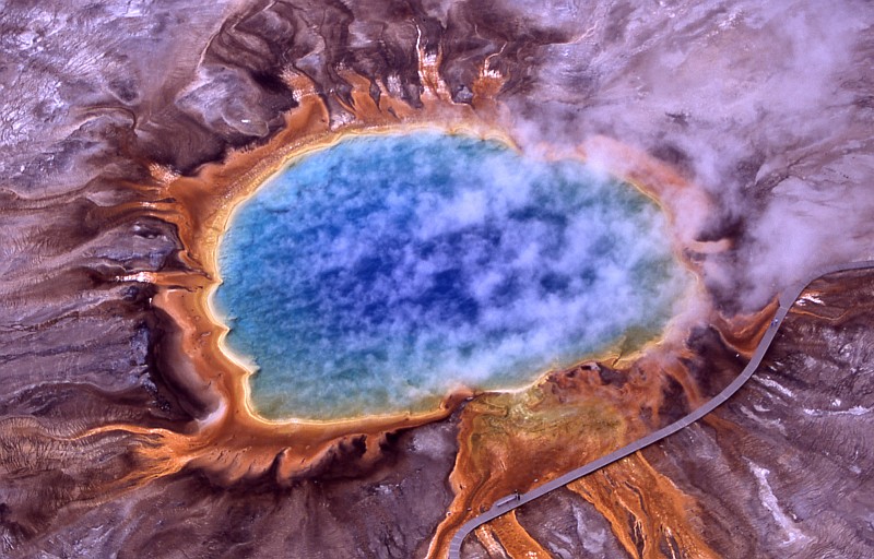 2. July 2001 Aerial Photograph of the Grand Prismatic Spring, Midway Geyser Basin, Yellowstone National Park, State of Wyoming, USA. Photo Credit: NPS Photo, Jim Peaco, July 2001. Yellowstone Digital Slide File - Midway & Lower Geyser Basin (http://www.nps.gov/archive/yell/slidefile/index.htm and http://www.nps.gov/archive/yell/slidefile/thermalfeatures/hotspringsterraces/midwaylower/Page.htm, Image 17708), Yellowstone National Park (http://www.nps.gov/yell), National Park Service (NPS, http://www.nps.gov), United States Department of the Interior (http://www.doi.gov), Government of the United States of America (USA).