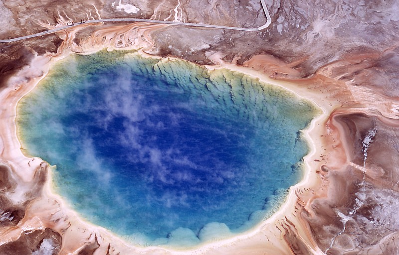 3. An Aerial Photo From 1973 of the Grand Prismatic Spring, Midway Geyser Basin, Yellowstone National Park, State of Wyoming, USA. Photo Credit: NPS Photo, A. Mebane, 1973. Yellowstone Digital Slide File - Midway & Lower Geyser Basin (http://www.nps.gov/archive/yell/slidefile/index.htm and http://www.nps.gov/archive/yell/slidefile/thermalfeatures/hotspringsterraces/midwaylower/Page.htm, Image 06120), Yellowstone National Park (http://www.nps.gov/yell), National Park Service (NPS, http://www.nps.gov), United States Department of the Interior (http://www.doi.gov), Government of the United States of America (USA).