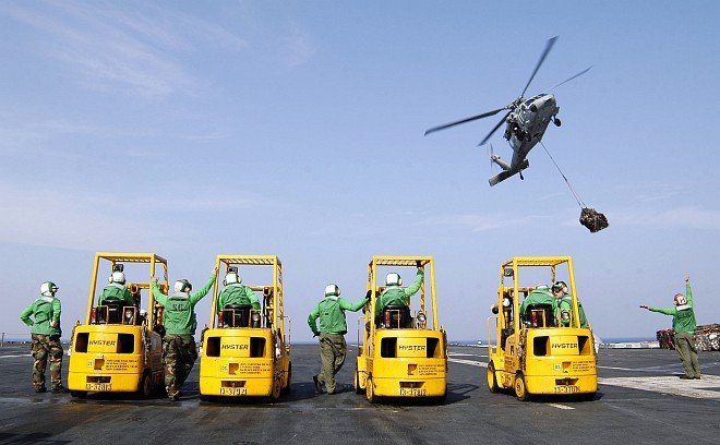 USS Abraham Lincoln (CVN 72) Sailors With Their Forklifts Wait for the MH-60S Knighthawk Helicopter to Deliver Supplies for Operation Unified Assistance, the International Humanitarian Relief Operation Triggered by The Great Earthquake and Catastrophic Tsunami of 2004 <http://ChamorroBible.org/gpw/gpw-The-Great-Earthquake-and-Catastrophic-Tsunami-of-2004.htm>. January 21, 2005, In the Indian Ocean Near the Kingdom of Thailand and Republik Indonesia. Photo Credit: Photographer's Mate Airman Jordon R. Beesley, Navy NewsStand - Eye on the Fleet Photo Gallery (http://www.news.navy.mil/view_photos.asp, 050121-N-4166B-025), United States Navy (USN, http://www.navy.mil), United States Department of Defense (DoD, http://www.DefenseLink.mil or http://www.dod.gov), Government of the United States of America (USA).