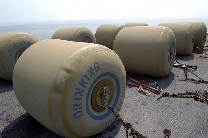 Hurricane Katrina Humanitarian Assistance, September 3, 2005, Gulf of Mexico: Eight Rubber Bladders Each Holding 500 Gallons of Fresh Drinking Water Aboard the Flight Deck of the Amphibious Assault Ship USS Bataan (LHD 5), United States Navy. Photo Credit: Photographer's Mate Airman Jeremy L. Grisham, Navy NewsStand - Eye on the Fleet Photo Gallery (http://www.news.navy.mil/view_photos.asp, 050903-N-8154G-244), United States Navy (USN, http://www.navy.mil); United States Department of Defense (DoD, http://www.DefenseLink.mil or http://www.dod.gov), Government of the United States of America (USA).