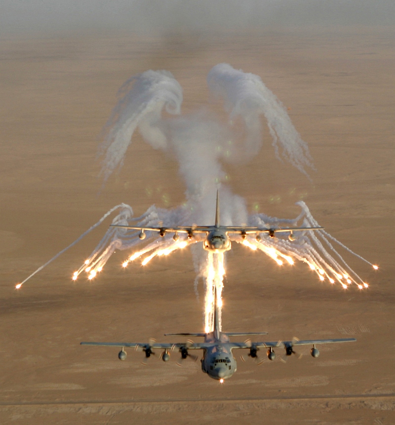 2. Aerial View of United States Marine Corps KC-130 Hercules Aircraft, Assigned to Marine Aerial Refueler-Transport Squadron Two Thirty Four (VMGR-234), As It Fires Flares Which Are Used to Counter an Attack by Surface to Air Missiles (SAMs or SAM) During Operation Iraqi Freedom, September 4, 2003, Al Jumhuriyah al Iraqiyah - Republic of Iraq. Photo Credit: Lance Cpl. Andrew Z. Williams, United States Marine Corps (USMC, http://www.usmc.mil); Defense Visual Information Center (DVIC, http://www.DoDMedia.osd.mil, DMSD0511421 and 030904M7837W014) and United States Marine Corps (USMC, http://www.usmc.mil), United States Department of Defense (DoD, http://www.DefenseLink.mil or http://www.dod.gov), Government of the United States of America (USA).
