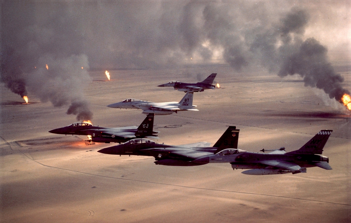 4. F-15E Strike Eagle, F-15C Eagle, and F-16A Fighting Falcon Fighter Jets Fly In Formation Over Burning Oil Wells During Operation Desert Storm, 1991, Dawlat al Kuwayt - State of Kuwait. Photo Credit: Tech. Sgt. Fernando Serna, Air Force Link - Photos (http://www.af.mil/photos, 071009-F-2911S-013, 'Operation Desert Storm'), United States Air Force (USAF, http://www.af.mil), United States Department of Defense (DoD, http://www.DefenseLink.mil or http://www.dod.gov), Government of the United States of America (USA).