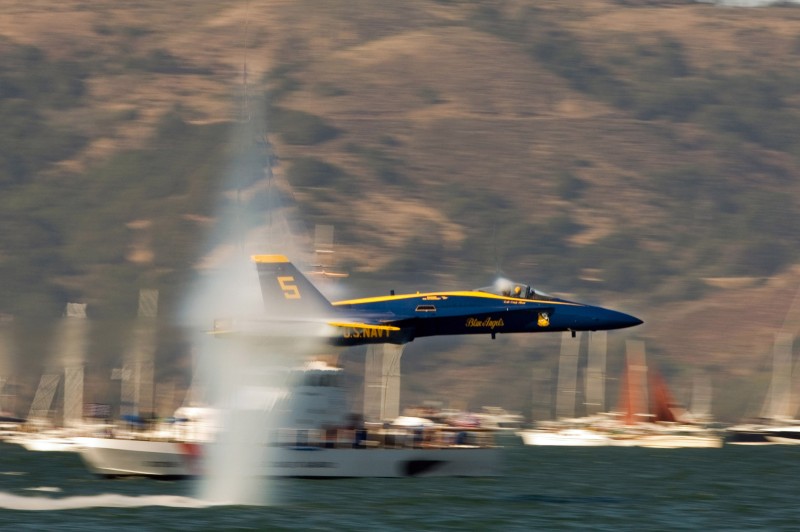 9. A U.S. Navy Blue Angels F/A-18 Hornet Fighter Jet Flying Low Over the Water at Speeds Just Below Mach 1 -- a Sneak Pass Maneuver Performed By the Lead Solo, October 9, 2005, San Francisco, State of California, USA. Photo Credit: Photographer's Mate 2nd Class Ryan Courtade, Navy NewsStand - Eye on the Fleet Photo Gallery (http://www.news.navy.mil/view_photos.asp, 051009-N-7559C-001), United States Navy (USN, http://www.navy.mil), United States Department of Defense (DoD, http://www.DefenseLink.mil or http://www.dod.gov), Government of the United States of America (USA).