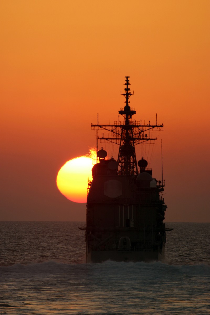 66. The Setting of the Sun Over the Arabian Gulf -- A Fiery Ball Painting the Sky Orange While Approaching the Horizon, November 9, 2004, Strait of Hormuz. Photo Credit: Cryptologic Technician 3rd Class Clayton S. Reyes, Navy NewsStand - Eye on the Fleet Photo Gallery (http://www.news.navy.mil/view_photos.asp, 041109-N-0000X-001), United States Navy (USN, http://www.navy.mil), United States Department of Defense (DoD, http://www.DefenseLink.mil or http://www.dod.gov), Government of the United States of America (USA).
